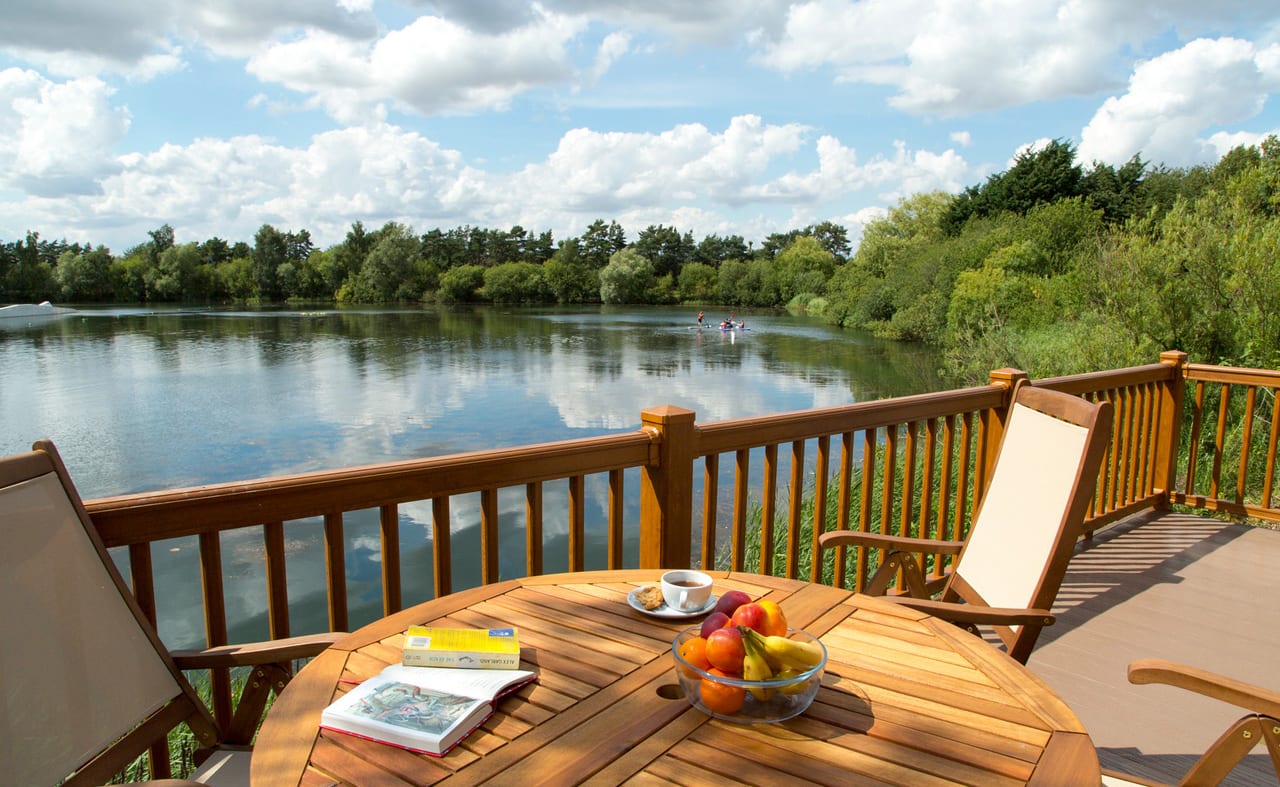 A view of the lake from one of our stunning lodges at Tattershall Lakes on a sunny day. image