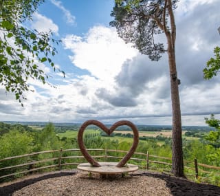 Our Sandy Balls holiday park. There is a wooden, heart-shaped bench that overlooks the holiday park. image