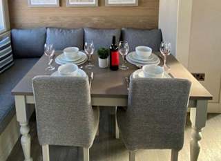 The dining area of one of our spacious static caravans in St Ives. Book your holiday now! image