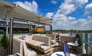 An image of an outdoor seating area on a balconey looking out to the river at one of our holiday parks. image