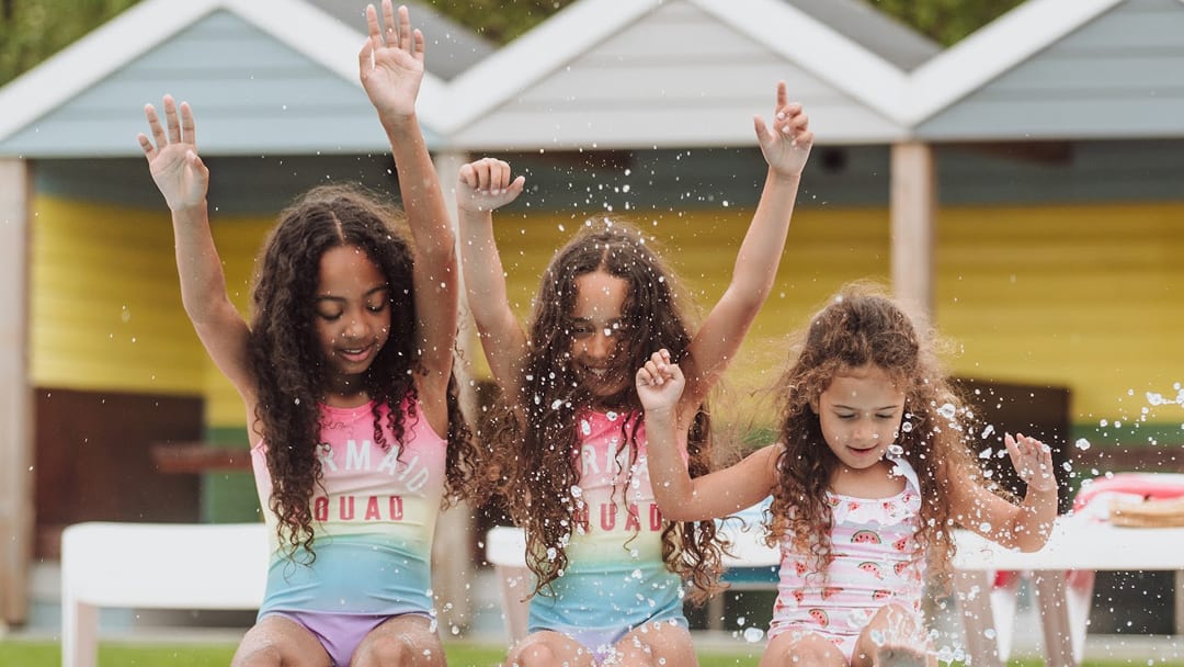 Girls playing in the outdoor pool at Newquay Bay Holiday Park.