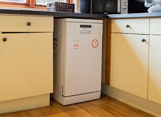 The interior of one of our woodland style holiday lodges. There's a spacious kitchen with various appliances. image