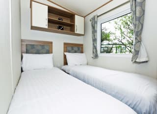 The twin bedroom of our bright and spacious luxury static caravan. The perfect way to stay. image