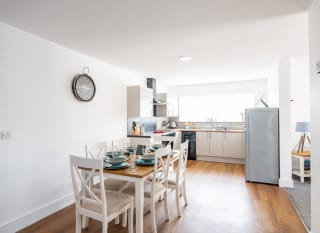 The kitchen and dining area of one of our spacious static caravans at Mersea Island. Book your holiday now! image