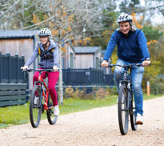 An image of two people cycling through on of our parks together. image
