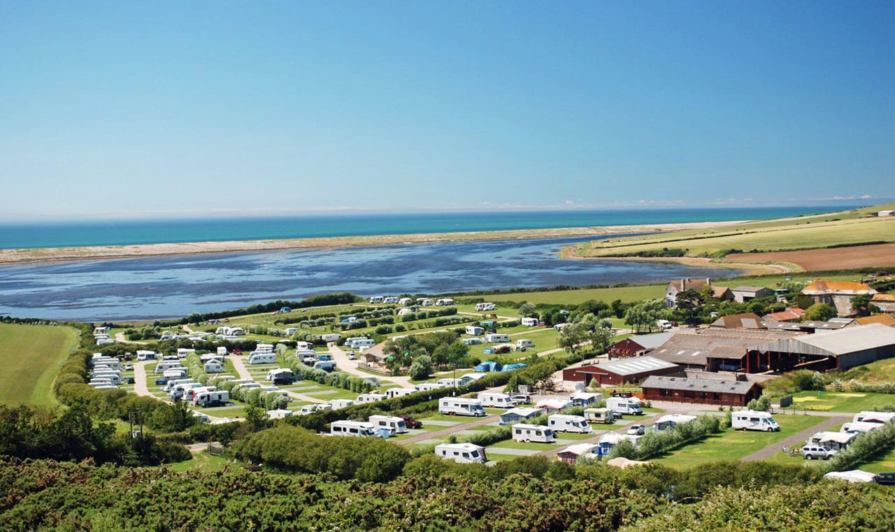 A drone image of our camping and touring park in Dorset, East Fleet Farm with views of the lagoon. image