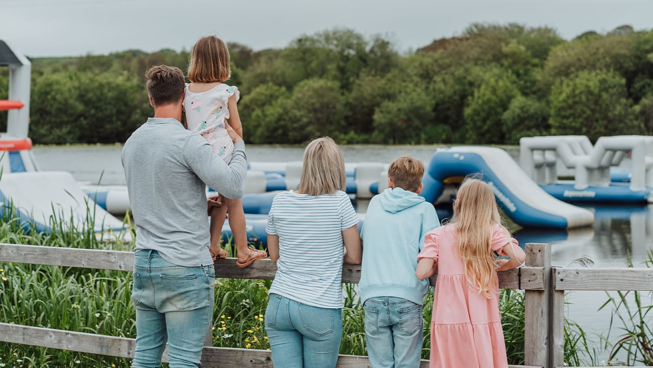 A young family looking over the watersports taking place on the lake at our stunning Retallack Resort & Spa.