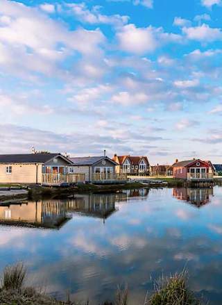 Holiday lodges looking out to a lake at The Bay Filey, Yorkshire, Away Resorts.