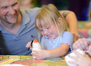 Young girl pottery painting at one of our Away Resorts parks. image