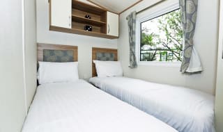 The twin bedroom of our bright and spacious luxury static caravan. The perfect way to stay. image