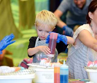 A young boy taking part in our tie dye activity.