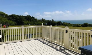 The decking area on a sunny day at one of our exclusive accommodations, The Seaview Lodge. Book your holiday now! image