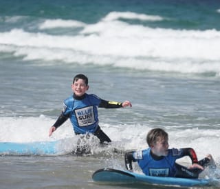 Two young boys enjoying their surf at Blue Surf School.