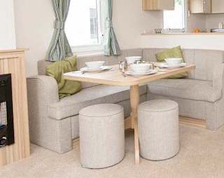 The living and dining area of our bright and spacious comfort static caravan. The perfect way to stay.