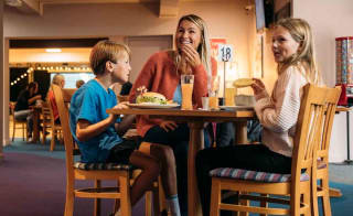 Family enjoying a bite to eat at our Newquay Bay Holiday Park. image