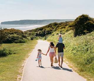 A young family walking to the beach, a stones throw away from our stunning Yorkshire resort, The Bay Filey.