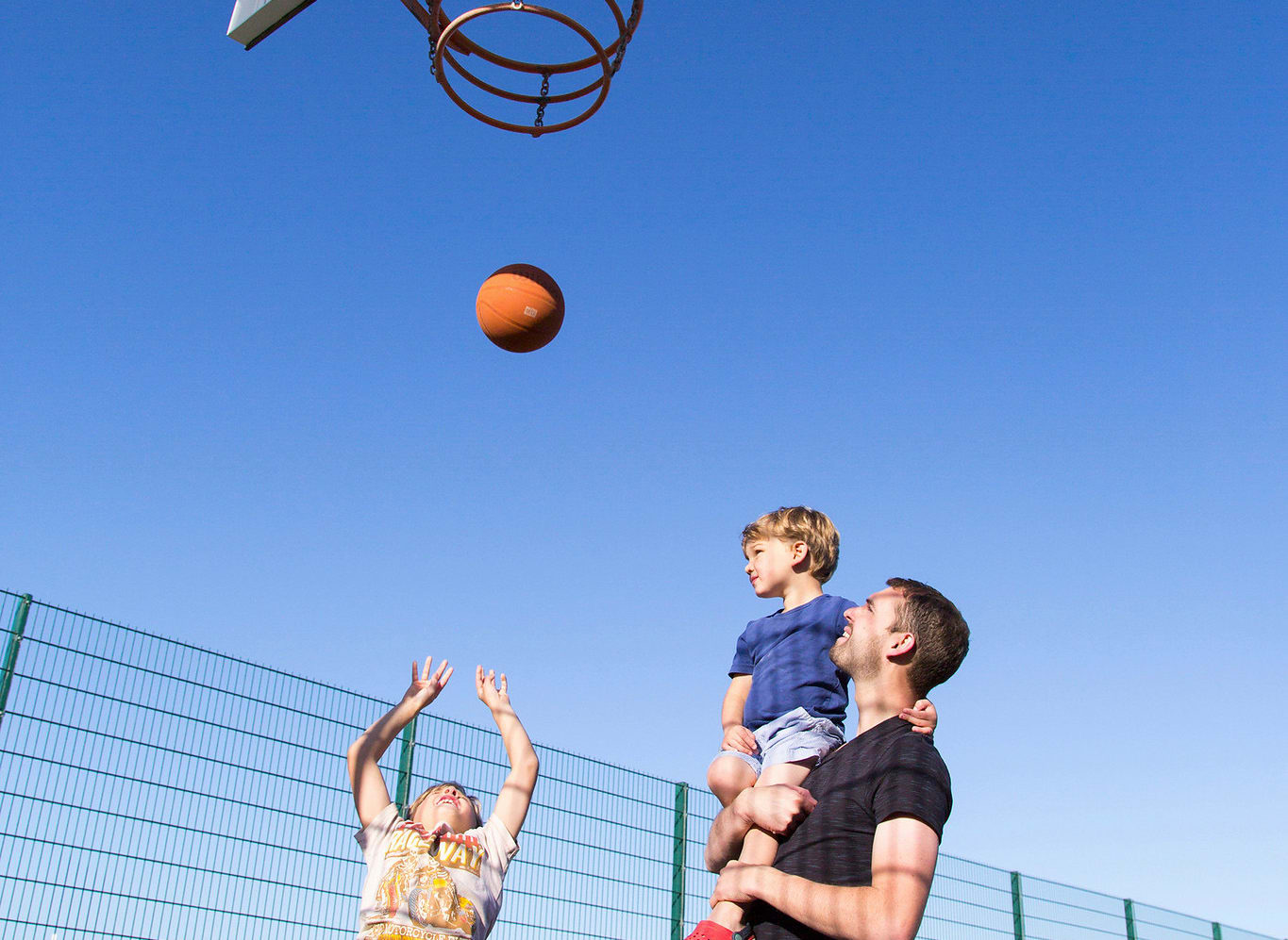 A family enjoying the outdoor sports court at our stunning park in North Wales, Barmouth Bay. image