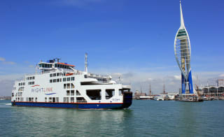 A clear summers day with a ferry crossing. image