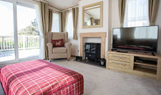 The lounge area of our bright and spacious indulgent static caravan. The perfect way to stay. image