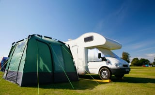 A tent and tourer in one of our holiday parks. image