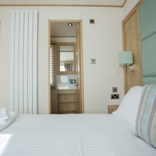 The double bedroom with en suite bathroom in our bright and spacious indulgent static caravan. The perfect way to stay.