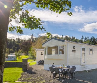 The exterior of a static caravan at our Moffat Manor holiday park in a summers day.