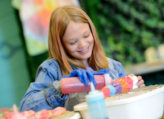 A young girl taking part in our tie dye crafts activity. image