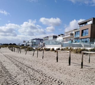 An image of Sandbanks Beach in Dorset. You can see the golden sand and houses overlooking the beach. image