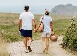 A happy couple walking hand in hand near one of our holiday parks. image