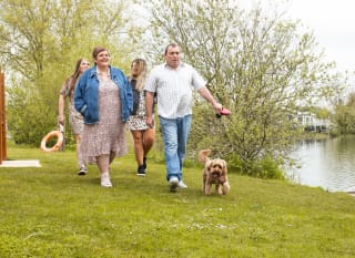 Family out walking their dog by the lake, what a great way to spend ownership days at Tattershall Lakes. image