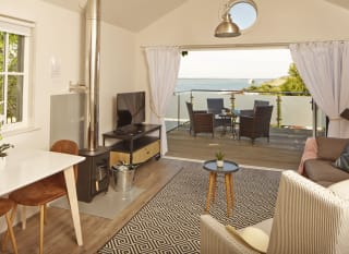The living area of one of our spacious Beach Lodges, with stunning views of the sea from the balcony. Book your holiday now! image