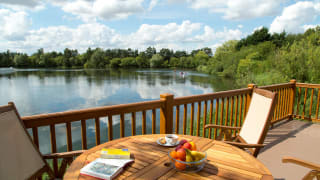 A view of the lake from one of our stunning lodges at Tattershall Lakes on a sunny day. image