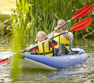 A man and child canoeing down the lake. image