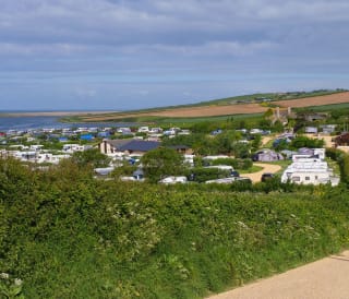 Mobile caravans parked with a wide angle view of the vast countryside and the lagoon located at our East Fleet Farm holiday park in Dorset.