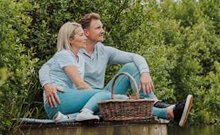 Couple enjoying a peaceful afternoon lakeside. image