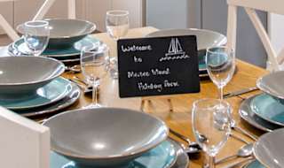 The kitchen and dining area of one of our spacious static caravans at Mersea Island. Book your holiday now! image