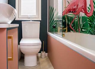 A clean and white bathroom with pink wooden accents on the washbasin and bathtub. The white shower curtain has a pink flamingo on it. image