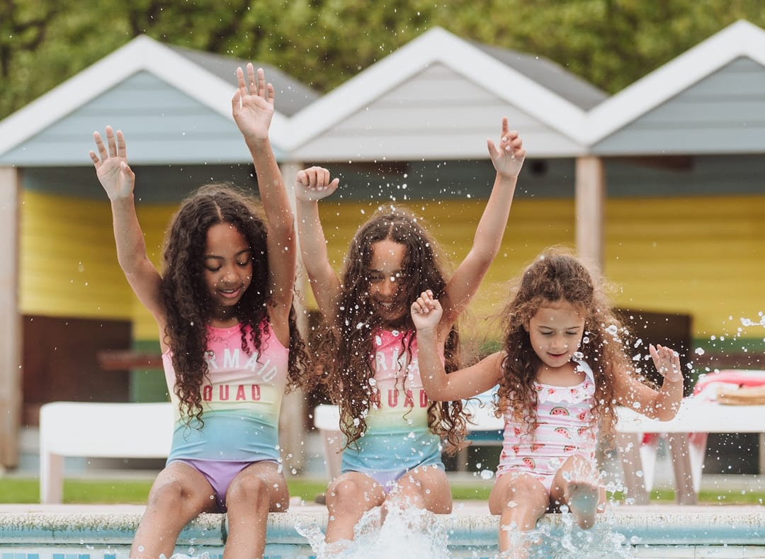 Girls playing in the outdoor pool at Newquay Bay Holiday Park. image