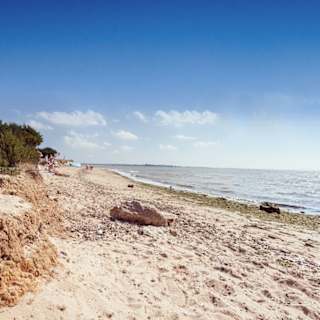 A hot summers day at the beach on Mersea Island, Essex. Book your caravan holiday with us.