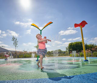 Children playing in our awesome outdoor splash pad at Appletree Holiday Park, Lincolnshire, on a sunny day.