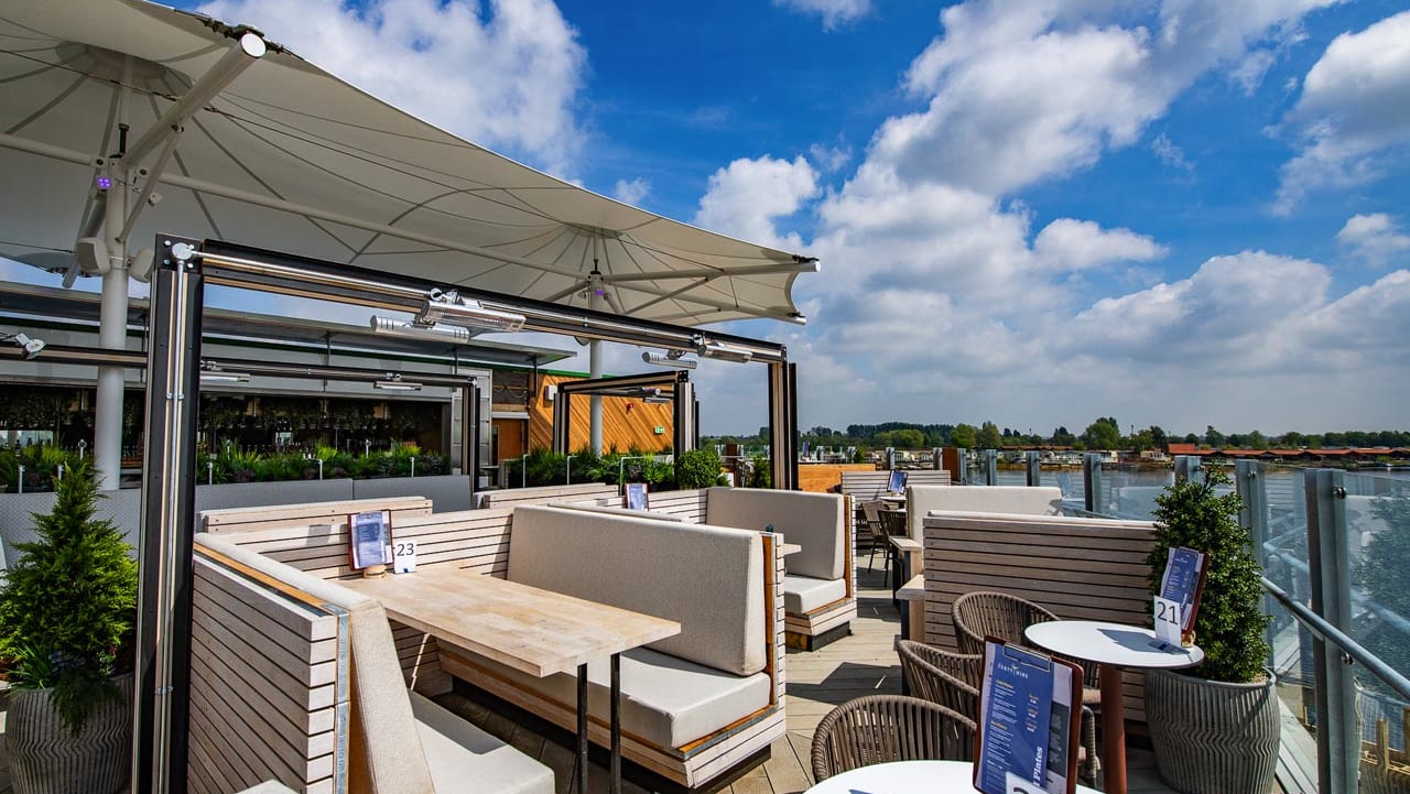 An image of an outdoor seating area on a balconey looking out to the river at one of our holiday parks.