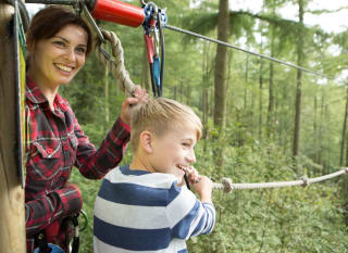 A young boy and female enjoying a day at Go Ape. image