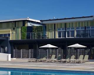 A sunny day looking out onto the heated outdoor swimming pool at our holiday park, Cleethorpes Pearl, Lincolnshire.
