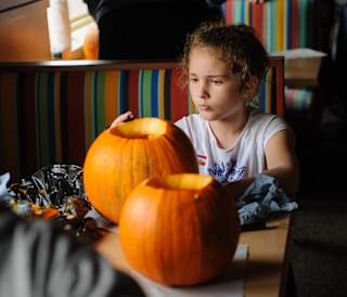 A young girl carving pumpkins at our holiday park.