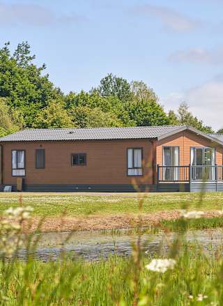 Over lake view of our lodges available to holiday at, Appletree Holiday Park.