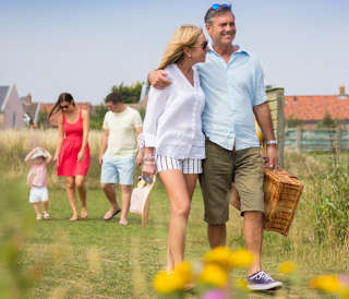 Family and small child taking a walk on a summers day.
