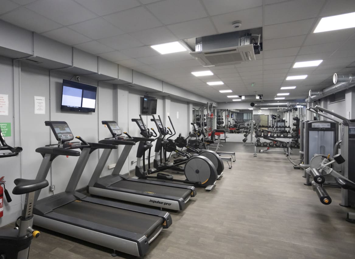 An image of the gym at our Dorset holiday park, Swanage Bay View. There are treadmills, bike machines, weights and so much more! image