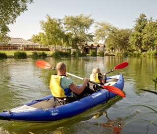 A father and daughter kayaking through the lake at one of our static caravan holiday parks, The Lakes Rookley.