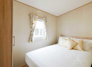 The double bedroom in our bright and spacious comfort static caravan. The perfect way to stay. image