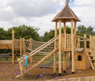 A child playing in the outdoor play area at our holiday park in Lincolnshire, Appletree.